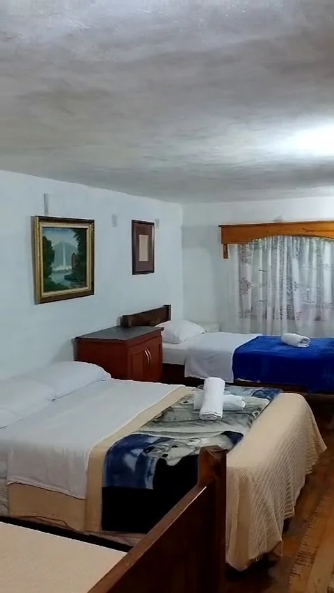 Habitación con varias camas y cuadros